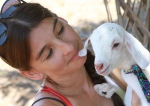 beautiful girl with cute baby goat