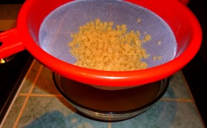 Straining the kefir grains